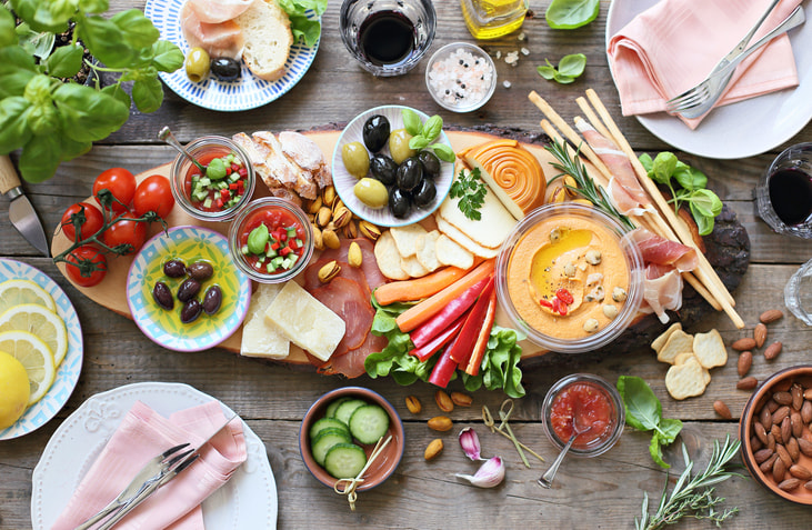 Table with sumptuous appetizers display.