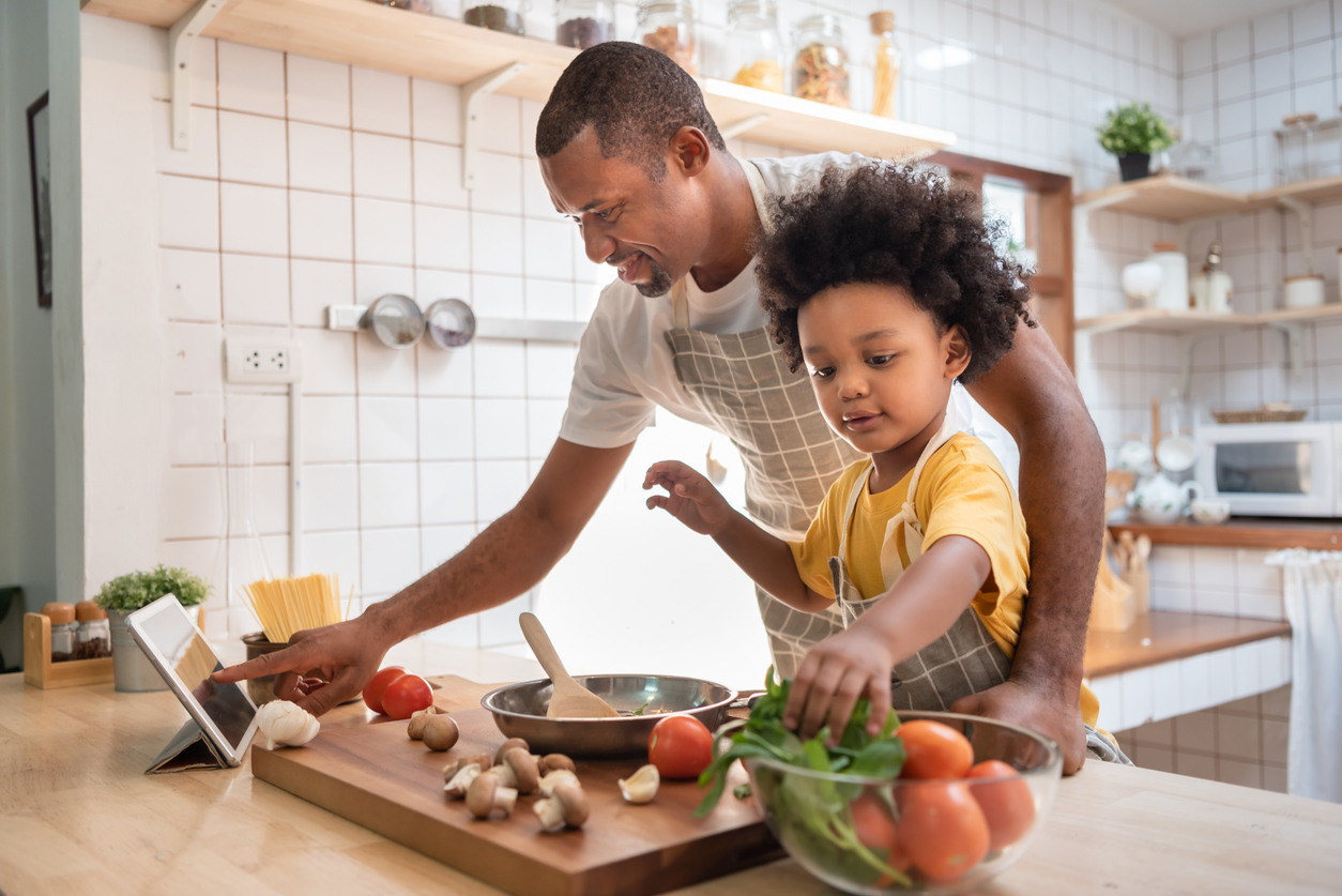 father and son cooking a meal